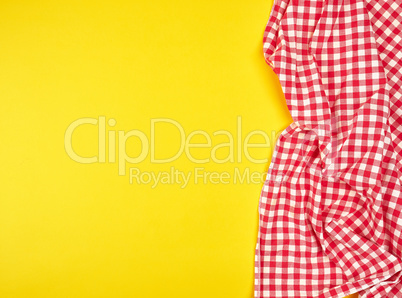 red kitchen towel in a cage on a yellow background