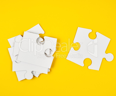 blank white big puzzles on yellow background