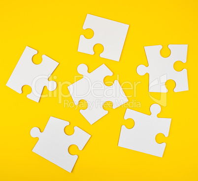 blank white big puzzles on yellow background