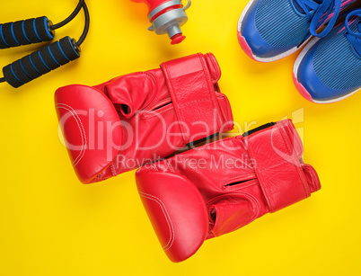 pair of red boxing gloves and blue sneakers