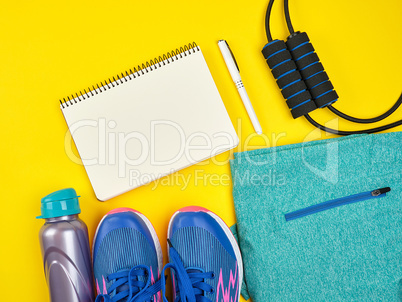 open empty notebook and sports women's clothing for sports and f