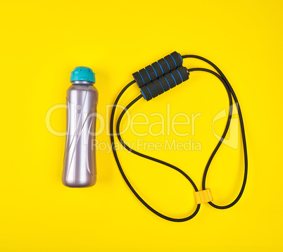 sports expander and water bottle on a yellow background