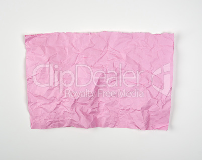 crumpled pink rectangular sheet of paper on a white background