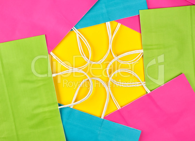 multi-colored paper shopping bags with white handles