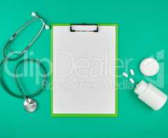 paper holder with empty white sheets, medical stethoscope