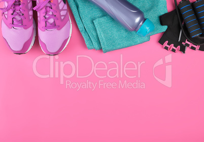 pink women's sneakers, a bottle of water, gloves and a jump rope