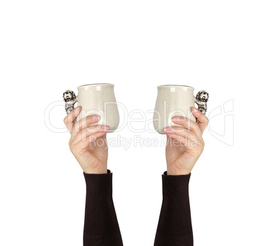 gray ceramic cup in female hand on a white background, hand rais