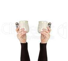 gray ceramic cup in female hand on a white background, hand rais