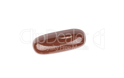 one brown gelatine pill isolated on white backgroung