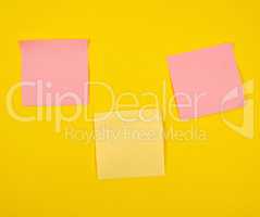 pink and yellow paper stickers pasted on yellow  background,