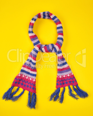 knitted scarf of multicolored wool threads tied in a knot