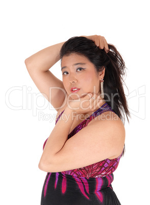 A lovely young Asian woman with hands on head