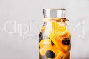 Bottle of Water with Orange and Blackberry.