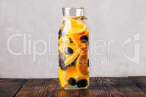 Bottle of Water with Orange and Blackberry.