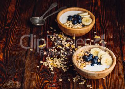Two Bowl of Granola with Banana and Blueberry.