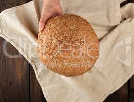 baked round rye bread with sunflower seeds