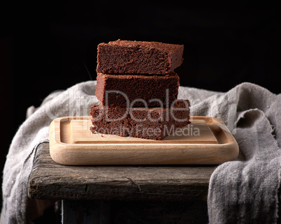 stack of baked square pieces of chocolate brownie cake