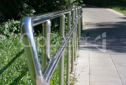 metal fence in park at dry sunny summer day