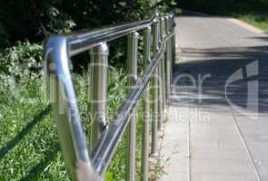 metal fence in park at dry sunny summer day