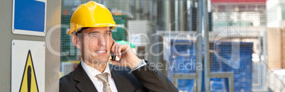 Construction Worker Builder on Building Site Talking on Phone Pa