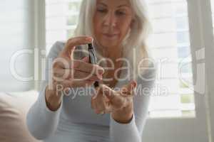 Active senior woman testing her blood sugar level with glucometer