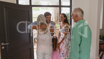 Active senior woman embracing at door in a comfortable home