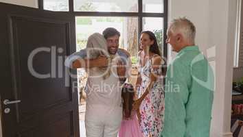 Active senior woman embracing at door in a comfortable home