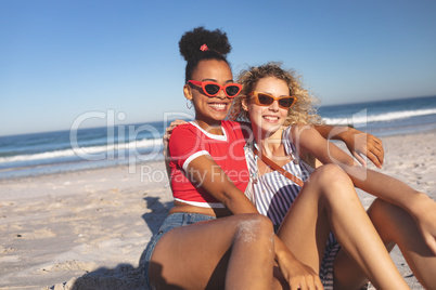 Female friends relaxing together on the beach