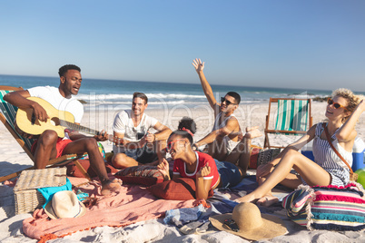 Group of friends having fun together on the beach