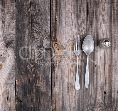 old aluminum false and fork on a gray wooden table, top view