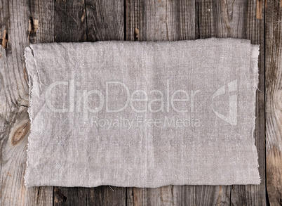 folded gray towel on wooden background