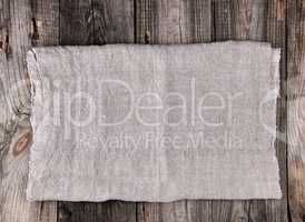 folded gray towel on wooden background