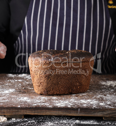 baked rye bread on a brown wooden board