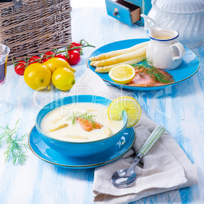 Cream of asparagus soup with salmon rolls and dill