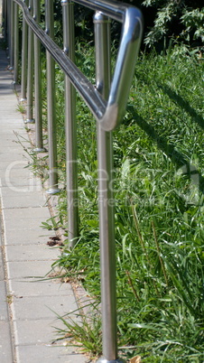 metal fence in park at dry sunny summer day