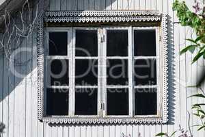 aged window of old white country house