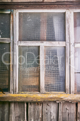 aged window of old white country house