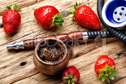 Smoking hookah on strawberry