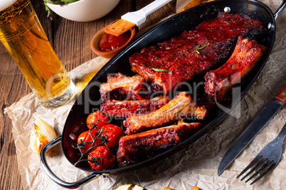 Grilled ribs in spicy marinade with salad and vegetables