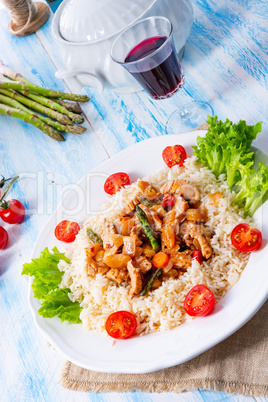 Turkey fricassee on rice with asparagus and paprika