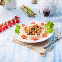 Turkey fricassee on rice with asparagus and paprika