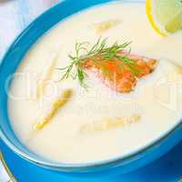 Cream of asparagus soup with salmon rolls and dill