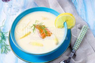 Cream of asparagus soup with salmon rolls and dill