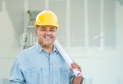 Hispanic Male Contractor with Blueprint Plans Wearing Hard Hat