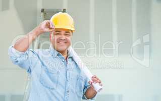 Hispanic Male Contractor with Blueprint Plans Wearing Hard Hat