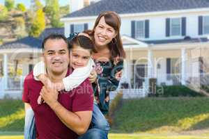 Happy Mixed Race Family Portrait In Front of Their House