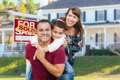 Happy Mixed Race Family In Front of House and Sold For Sale Sign