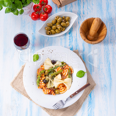 colorful farfalle with green asparagus olives and parma ham