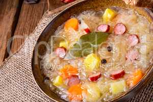 rustic sauerkraut soup with bacon and sausage