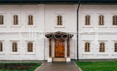 White Wall with Wooden Door, Porch and Windows.